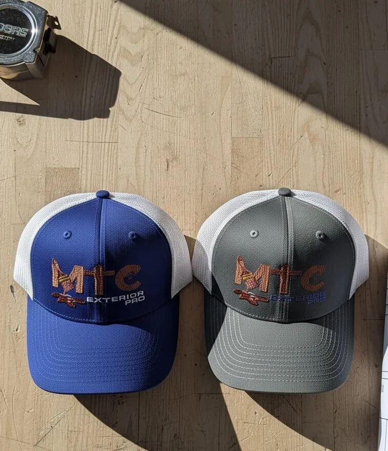 Custom embroidered MTC Exterior Pro trucker hats in blue and gray